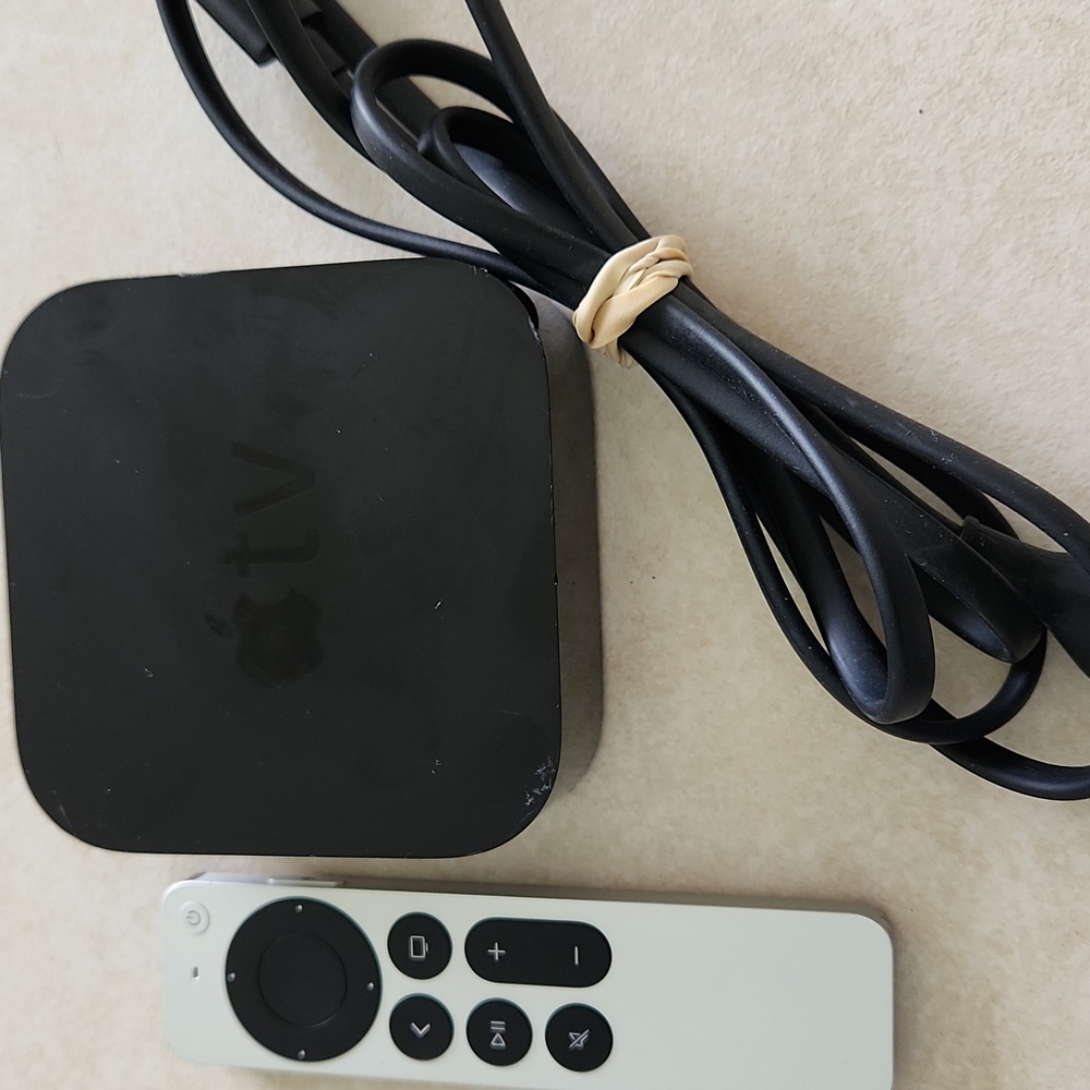 Apple TV box, cord, remote